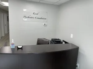 Front view of the front desk and the clinic's logo